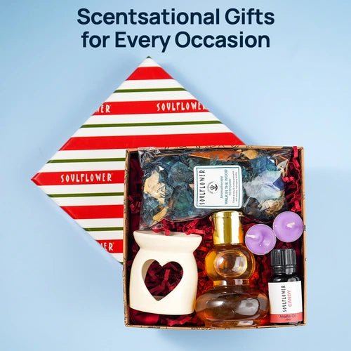 Soulflower Delight Gift Box featuring an aroma diffuser, essential oils, a small decorative container, and dried flowers, with a festive gift box.
