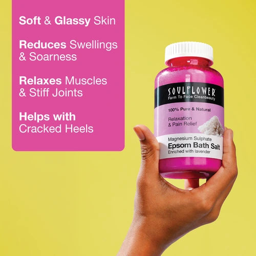 Hand holding Soulflower Epsom Bath Salt bottle against a yellow background, with text highlighting benefits like soft skin, reduced swelling, relaxed muscles, and relief from cracked heels