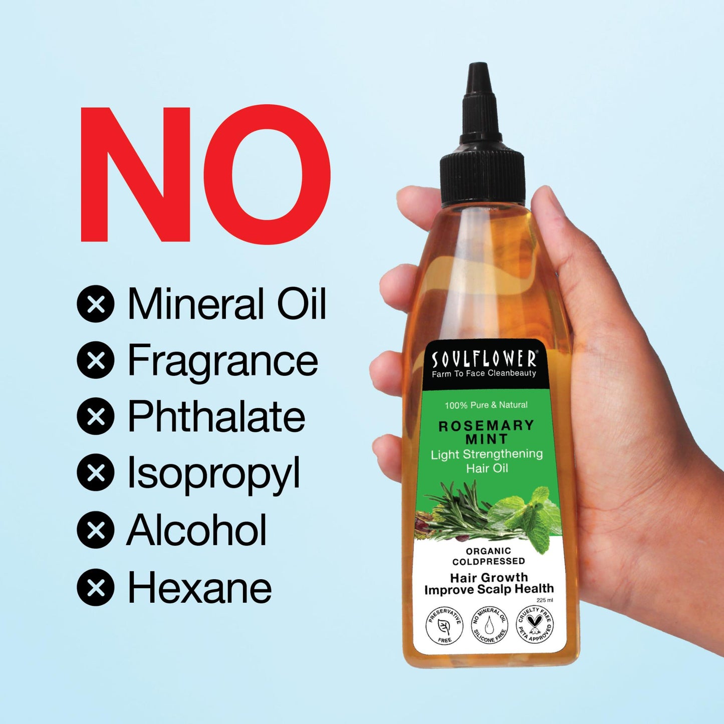 Hand holding Soulflower Rosemary Mint Hair Oil with a bold 'NO' list highlighting it's free from mineral oil, fragrance, phthalate, isopropyl, alcohol, and hexane.