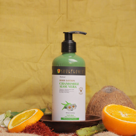 Image of Herbal Chamomile Aloe Vera Body Lotion for Silky Soft Skin alongside Saffron, Orange slices and Coconut