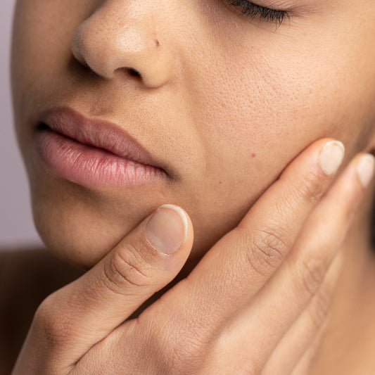 Image of person touching their skin and being concerned about it being dry and dehydrated.