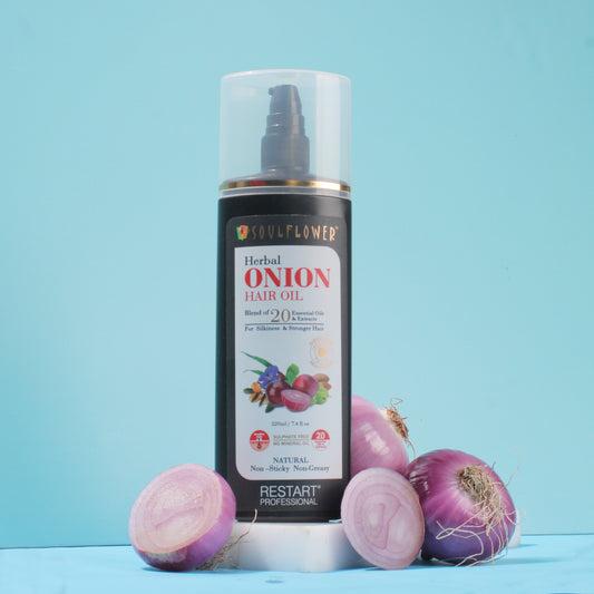 Image of Onion Hair Oil placed alongside onions 