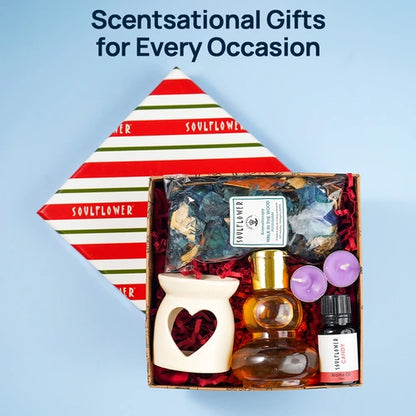 Soulflower Delight Gift Box featuring an aroma diffuser, essential oils, a small decorative container, and dried flowers, with a festive gift box.