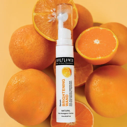 Soulflower Vitamin C Brightening Serum surrounded by fresh oranges, showcasing its natural formula for glowing skin.
